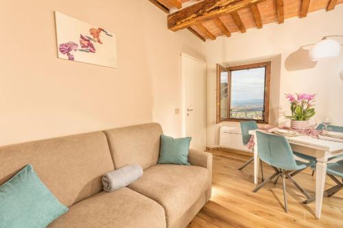 a living room with a couch and a table at Palazzo Falcinelli Luxury Room in Montepulciano Center with Air Conditioning and Elevator in Montepulciano