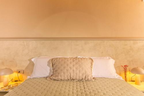 a bed with a pillow on top of it at Palazzo Falcinelli Luxury Room in Montepulciano Center with Air Conditioning and Elevator in Montepulciano