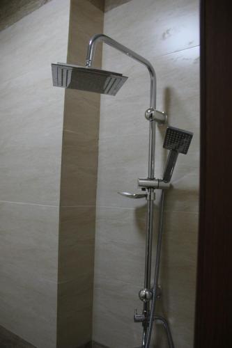 a shower with a shower head in a bathroom at Colour in Baku