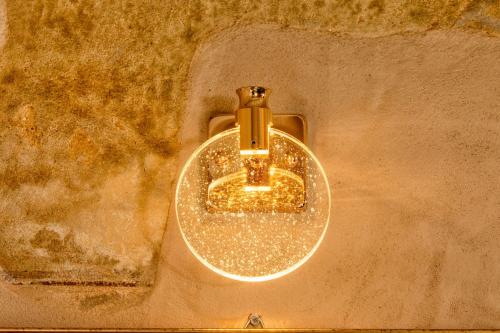 a light hanging on the side of a wall at Palazzo Falcinelli Luxury Room in Montepulciano Center with Air Conditioning and Elevator in Montepulciano