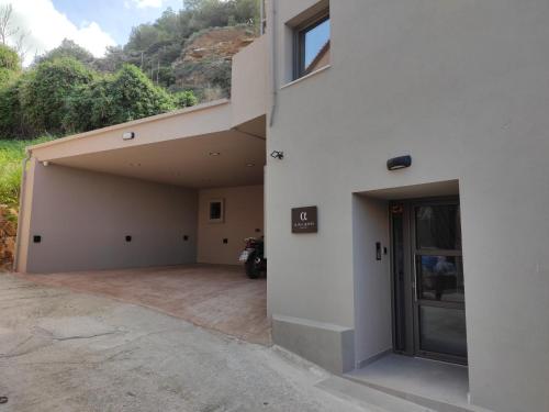an empty house with a garage and a building at ALPHA SUITES in Chania Town