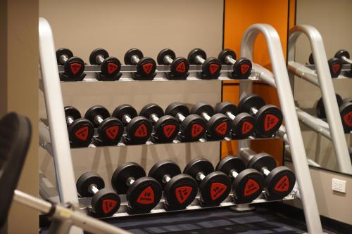 a rack of dumbbells in a gym at Novotel Rayong Star Convention Centre in Rayong