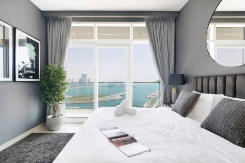 a bedroom with a white bed with a large window at Marina Skyline View & Dubai Harbour Beachfront in Dubai
