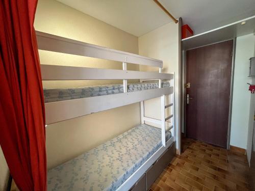 a bedroom with two bunk beds in a room at Studio cabine avec piscine, parking sécurisé et accès direct plage à Saint-Cyprien - FR-1-753-15 in Saint-Cyprien