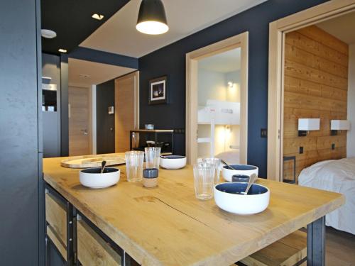 a wooden counter with bowls and glasses on it in a bedroom at Appartement Les Arcs 1800, 3 pièces, 4 personnes - FR-1-346-569 in Bourg-Saint-Maurice