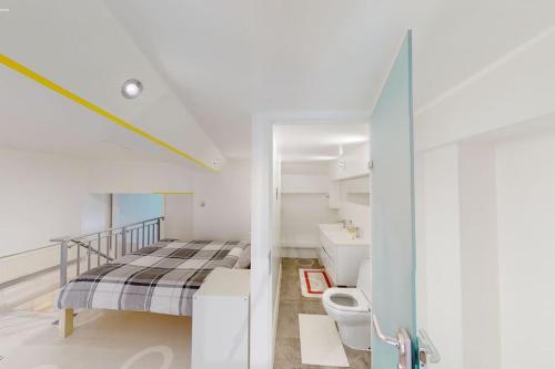 a white bedroom with a bed and a sink at Sleeps up to 4 - City Centre in Nottingham