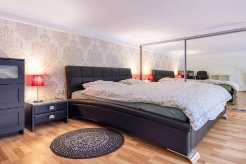 a bedroom with a large bed and a mirror at Marianna apartment in Budapest