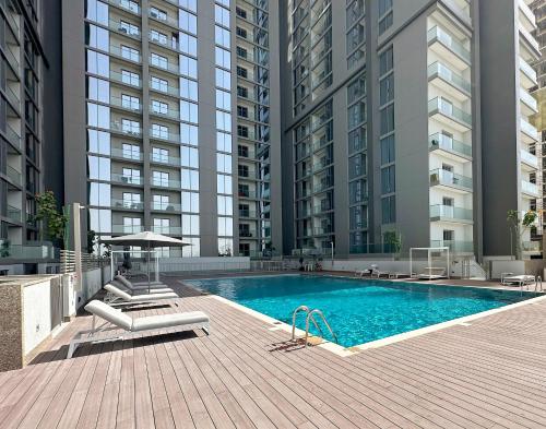 a swimming pool in a building with tall buildings at New 2 bedroom in Meydan - Green Area in Dubai