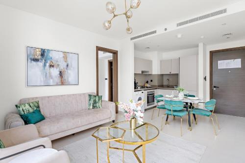 a living room with a couch and a table at New 2 bedroom in Meydan - Green Area in Dubai