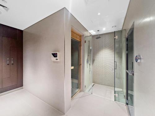 a bathroom with a shower and a walk in shower at New 2 bedroom in Meydan - Green Area in Dubai