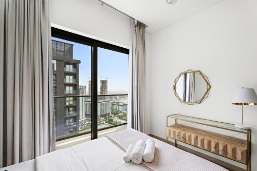 a bedroom with a bed and a large window at New 2 bedroom in Meydan - Green Area in Dubai