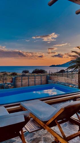 a swimming pool with a view of the ocean at Andromeda in Tsoútsouros