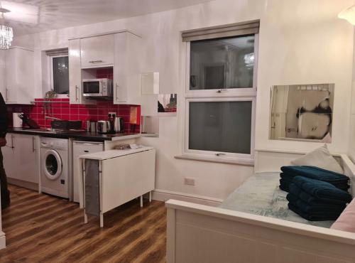 a kitchen with a sink and a stove top oven at Corbyn Street Flat 2 in London