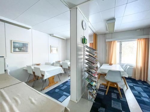 a room with a table and chairs and a dining room at Sova Guesthouse in Sodankylä