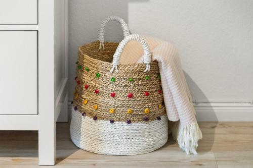 a basket with a scarf on top of a floor at Gut Oehe in Maasholm