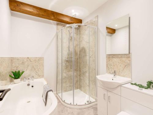 a bathroom with a shower and a tub and a sink at 2 Bed in Umberleigh 88605 in Chittlehampton