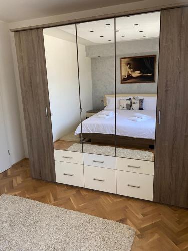 a bedroom with a large closet with a bed in it at Astralis Factory Apartments- FLY in Zagreb