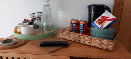 Una mesa con dos cestas y una botella. en Don Muir Guesthouse en Oban