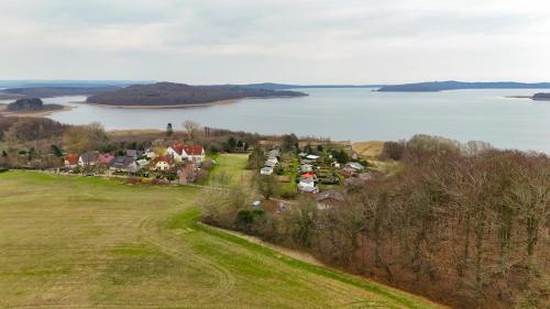 an aerial view of a town next to a body of water at Inselhotel kleiner Bodden in Buschvitz