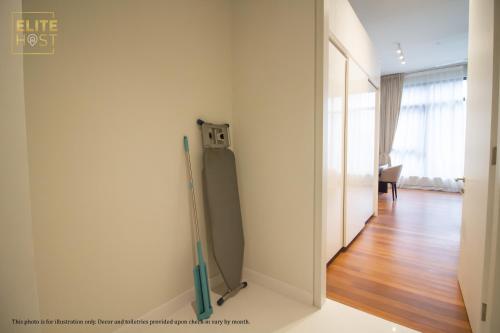 a room with a wall with a mirror and a door at PAVILION EMBASSY KLCC By ELITE HOST in Kuala Lumpur