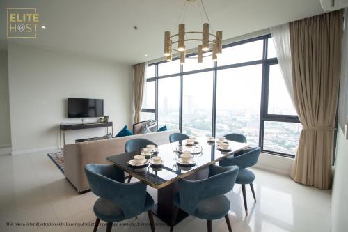 a dining room with a table and chairs and a large window at PAVILION EMBASSY KLCC By ELITE HOST in Kuala Lumpur