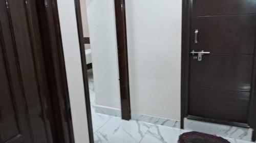 uma casa de banho com uma porta e um espelho em 7HILLSHOMESTAY em Tirupati