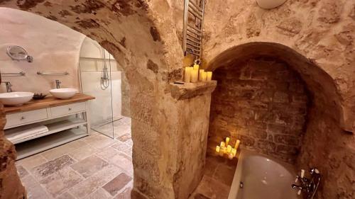 a stone bathroom with a sink and a bath tub at Serenity, Meditation at Notre Dame in Paris