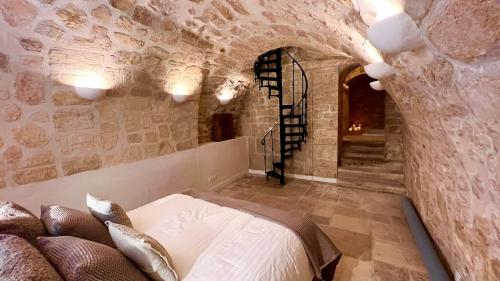 a bedroom with a bed in a stone wall at Serenity, Meditation at Notre Dame in Paris