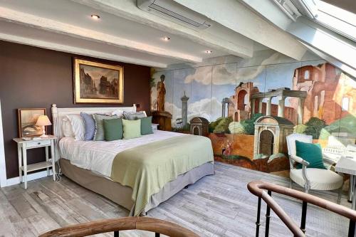 a bedroom with a large bed with a painting on the wall at Rooftop Triplex with Garden at Notre Dame in Paris