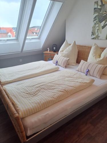 a large bed in a room with two windows at Haus am See in Muhr amSee