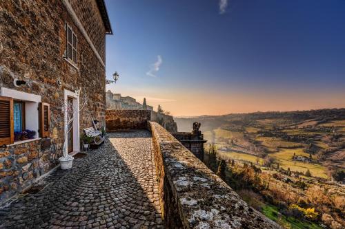 a stone building with a view of a valley at La Casa Bianca with parking and view in Orvieto