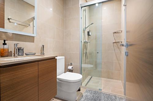 a bathroom with a toilet and a glass shower at New 2 Bedroom in Creek Reserve in Dubai