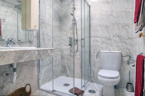 a bathroom with a toilet and a glass shower at Casa Natalie La Marina in Puerto Calero