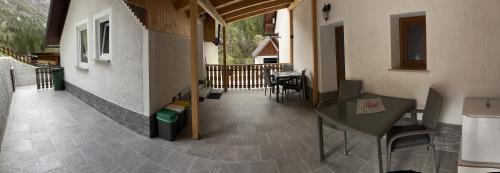 a balcony of a house with a table and chairs at Apartmaji in Sobe Cuder in Soča