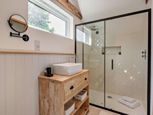 a bathroom with a sink and a glass shower at 1 Bed in Wix 92565 in Wix