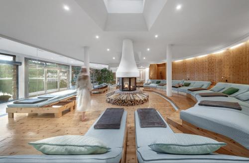 a living room with many beds and a fireplace at Hotel Hochschober in Ebene Reichenau