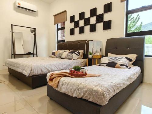 a bedroom with two beds and a table with a basket at 15-19Pax SemiD Near Highwy W/Pool Table&Karaoke in Ipoh