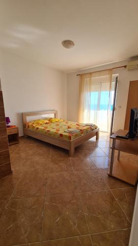 a bedroom with a bed in the corner of a room at Apartments Mare in Ulcinj