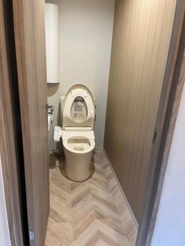 a bathroom with a toilet with the lid up at Business Hotel Legato in Tokyo