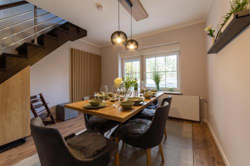 a dining room with a wooden table and chairs at GREEN ViEW APARTMENTS in Kaludjerske Bare