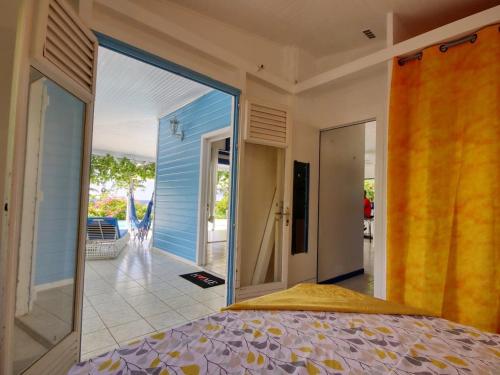 sypialnia z dużymi szklanymi drzwiami prowadzącymi na patio w obiekcie Villa de 2 chambres avec vue sur la mer piscine privee et jacuzzi a Saint Pierre a 1 km de la plage w mieście Saint-Pierre
