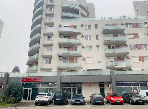 a large building with cars parked in front of it at Zen Apartment Oradea - FREE Parking in Oradea
