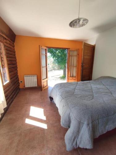 a bedroom with a large bed and an open door at LaFinca in Las Heras