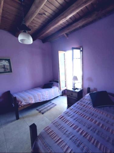 a bedroom with two beds and a window at LaFinca in Las Heras