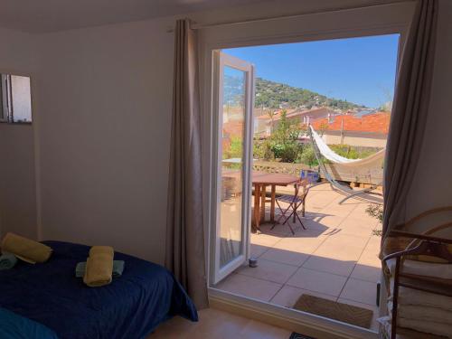 a bedroom with a bed and a sliding glass door to a patio at La terrasse des capucines in Sète