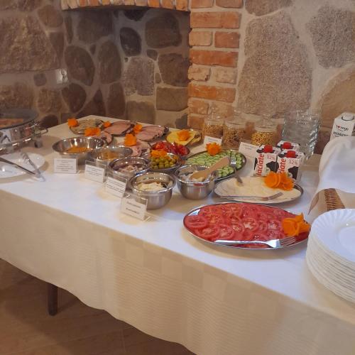 a table with several plates of food on it at Dom Krawca - pod Chojnikiem in Jelenia Góra