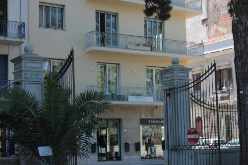a building with a gate in front of a street at Sunset Guest House in Reggio Calabria