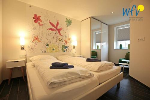 En eller flere senge i et værelse på Bootshaus in den Duenen - 1 Ferienwohnung "Unter Fischen"