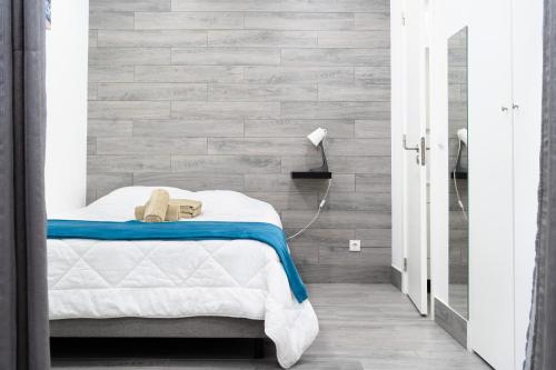 a bedroom with a bed and a brick wall at Casa da Carochinha in Nazaré
