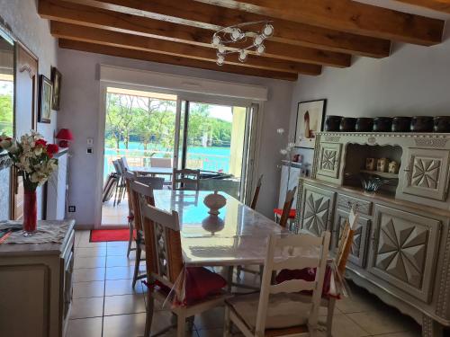 a kitchen and dining room with a table and chairs at GITE DE CHARME in Changey